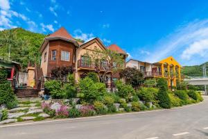 a house with a landscaping in front of it at Hongcheon Ganggaae in Hongcheon