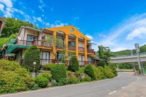 an orange house with a balcony on a street at Hongcheon Ganggaae in Hongcheon