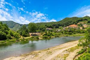 a river with a town and mountains in the background at Hongcheon Ganggaae in Hongcheon +43 photos
