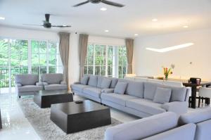 a living room with a couch and a table at Riverview Bungalow in Cameron Highlands in Tanah Rata