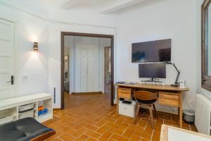 a room with a desk with a computer on it at Luxury Villa El Turo in Castellví de Rosanés