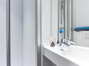 a bathroom with a sink and a mirror at hotelF1 Compiègne in Venette