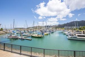 a bunch of boats docked in a harbor at Blue on Blue Apartment 1015 in Nelly Bay