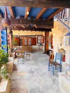 a stone patio with chairs and tables in a building at Byzantino Omodos House in Omodos