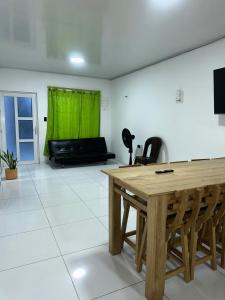 a living room with a wooden table and a couch at Cabaña linamar in Coveñas