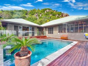 a house with a swimming pool on a deck at Absolute Beachfront and Pool House in Horseshoe Bay