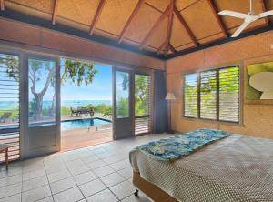 a bedroom with a bed and a view of a pool at Absolute Beachfront and Pool House in Horseshoe Bay