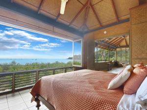 a bedroom with a bed with a view of the ocean at Absolute Beachfront and Pool House in Horseshoe Bay