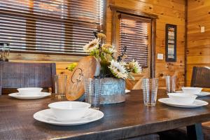 a wooden table with plates and bowls on it at Cedar Splash in Sevierville