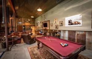 a living room with a pool table in it at Couples Country Getaway in Pagosa Springs