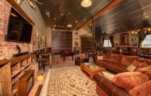 a large living room with a couch and a tv at Couples Country Getaway in Pagosa Springs