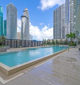 a large swimming pool in a city with tall buildings at Viceroy Residences in Miami
