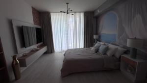 a bedroom with a large bed and a large window at Viceroy Residences in Miami +18 photos