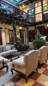 a lobby with couches and chairs in a building at Posada de Cantuña in Quito