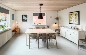 a kitchen and dining room with a table and chairs at Beautiful Home In Allinge With Wifi in Allinge