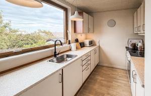 a kitchen with a sink and a window at Beautiful Home In Allinge With Wifi in Allinge
