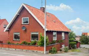 a red brick house with an orange roof at Beautiful Home In Allinge With Wifi in Allinge +7 photos
