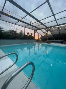 a large swimming pool with a large blue pool at Hotel-Style Private Suite-Lake View-Gardens in Lake Wales