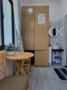 a small room with a table and a sink at Một Eco-Lodge in Tân Phú