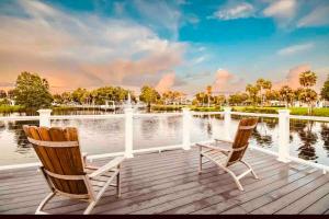 two chairs sitting on a deck next to a body of water at Brisa Marina Suites in New Port Richey
