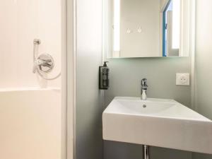 a bathroom with a white sink and a mirror at ibis budget Nanterre la Defense in Nanterre +54 photos