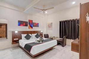 a hotel room with a bed and a bathroom at Super Townhouse Hotel O Benchmark in Indore
