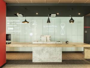 a counter in a room with a sign on the wall at Ibis Muenchen City Ost in Munich