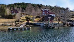 a dock in the middle of a body of water at Nesheim Cabin-By-The-Sea in Øygarden