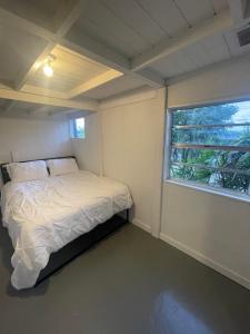 a small bedroom with a bed and a window at Hotel-Style Private Suite-Lake View-Gardens in Lake Wales +57 photos