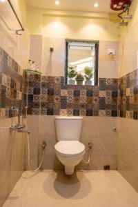 a bathroom with a toilet and a shower and a window at Astoria House in New Town +15 photos