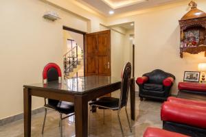 a dining room with a wooden table and chairs at Astoria House in New Town