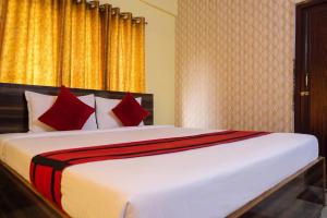 a bedroom with a large bed with red pillows at Astoria House in New Town