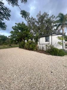 a house with a gravel driveway in front of it at Hotel-Style Private Suite-Lake View-Gardens in Lake Wales