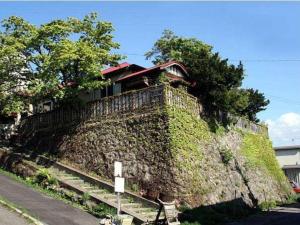 a house on top of a stone wall at The Otaornai Backpacker's Hostel Morinoki in Otaru +30 photos