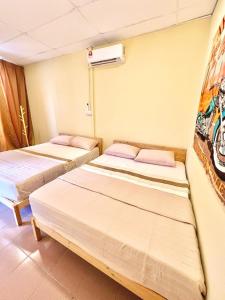 a room with two beds in a room at Camp Fire Homestay 2602 in Mersing