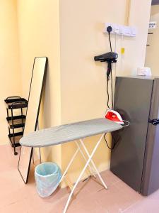 a desk with a phone sitting on top of it at Camp Fire Homestay 2602 in Mersing +14 photos
