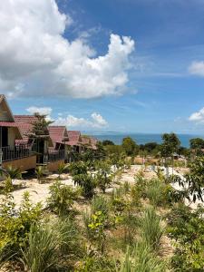 a row of houses with the ocean in the background at Sunrise Bungalows in Kaôh Rŭng (3)