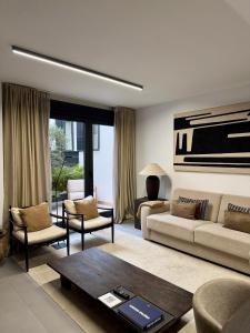 a living room with a couch and a table at Casa Amayuma - Málaga Centro Histórico in Málaga