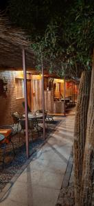 a patio with tables and chairs in a building at Lalck Cketi Hotelería y Turismo in San Pedro de Atacama