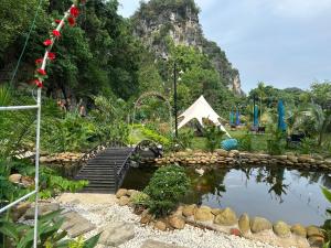 a pond in a park with a mountain in the background at Hen Camping- Coffee --------- Free if you have tent in Ninh Binh +46 photos