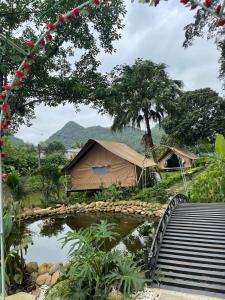 a tent with a pond and a bridge at Hen Camping- Coffee --------- Free if you have tent in Ninh Binh
