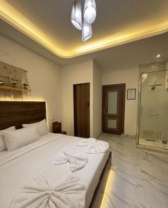a bedroom with a bed with towels on it at Maravia downtown hotel in Cairo +49 photos
