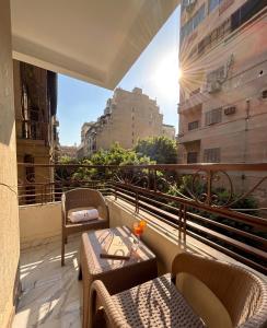 a balcony with tables and chairs on a building at Maravia downtown hotel in Cairo