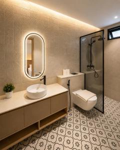a bathroom with a sink and a toilet and a mirror at ISA Hotel Amber Road in Singapore