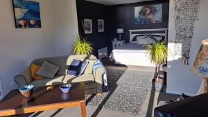 a living room with a couch and a bed at Christchurch - Port Levy, Bed & Breakfast in Port Levy