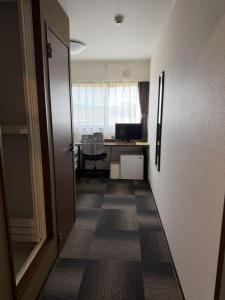 an office with a desk and a computer in a room at Hotel The Namie Terrace in Namie