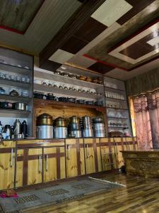 a kitchen with wooden cabinets with pots and pans at Dosho pa in Dah