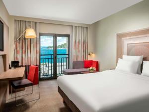 a hotel room with a bed and a balcony at Novotel Istanbul Bosphorus Hotel in Istanbul +222 photos