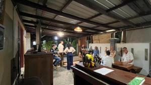 a group of people standing around in a room at Jessies Beach House in Pulau Lutung