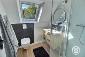 a bathroom with a shower and a sink and a mirror at Ty prad in Lanvellec +25 photos